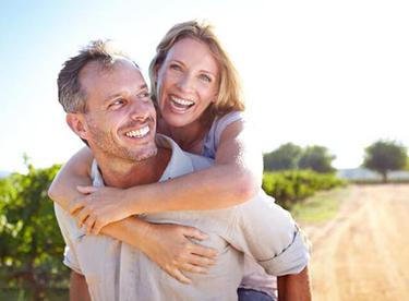 couple enjoying outdoors piggyback